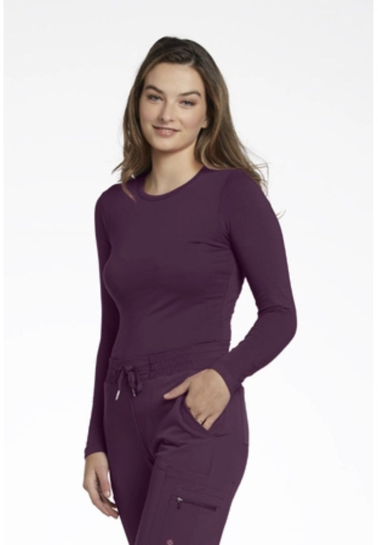 Woman wearing a White Cross 207 underscrub in Pickled Beet set on a white background