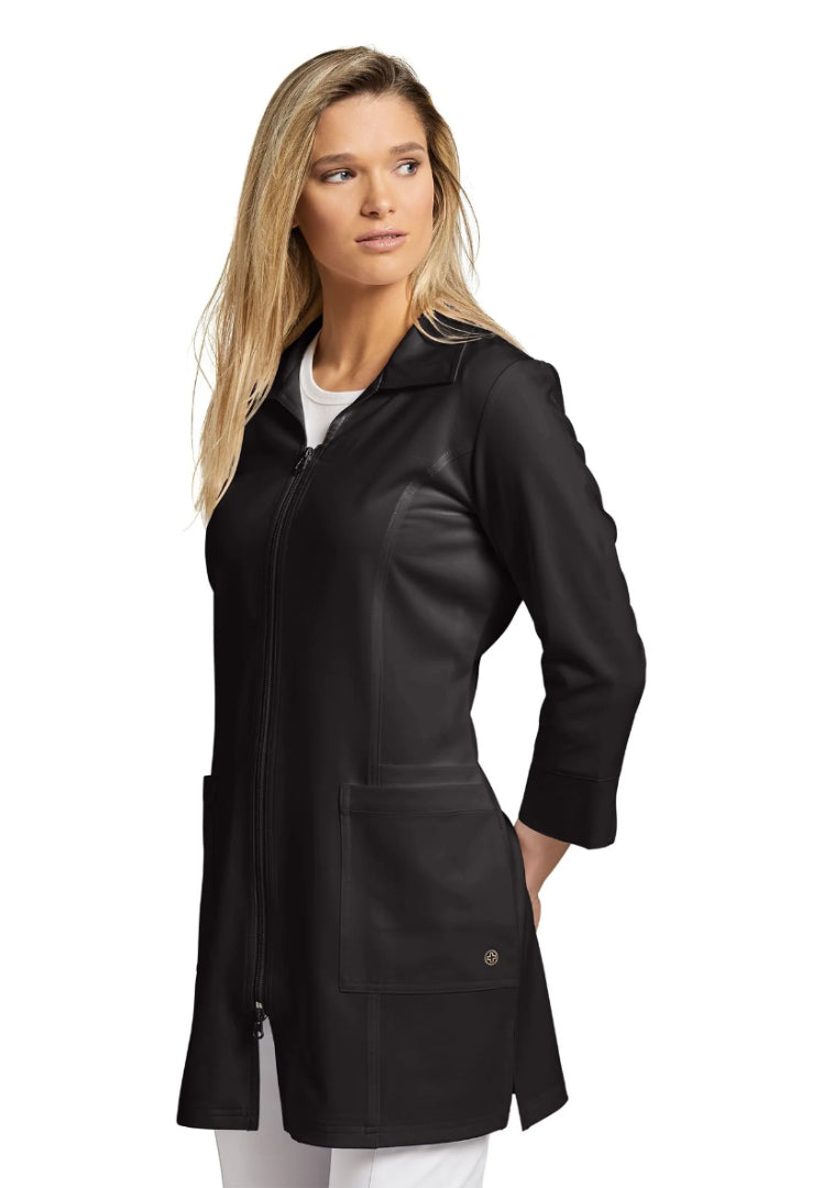 Woman wearing a White Cross 2817 black lab coat on a white background