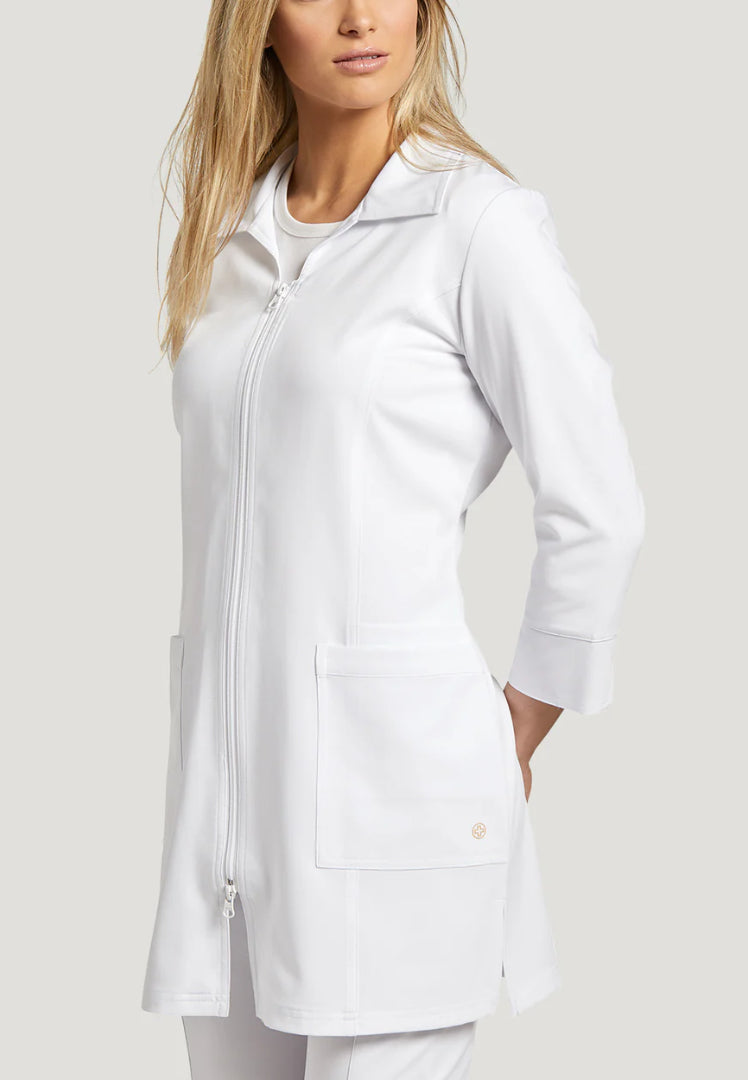 Woman wearing a White Cross 2817 white medical lab coat on a plain background