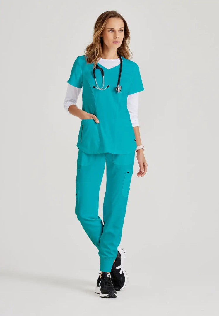 Grey's Anatomy™ Spandex Stretch "Carly" 3-Pocket Curved V-Neck Scrub Top - Teal - The Uniform Store