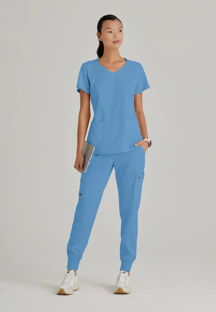 Grey's Anatomy™ Spandex Stretch "Carly" 3-Pocket Curved V-Neck Scrub Top - Ciel Blue