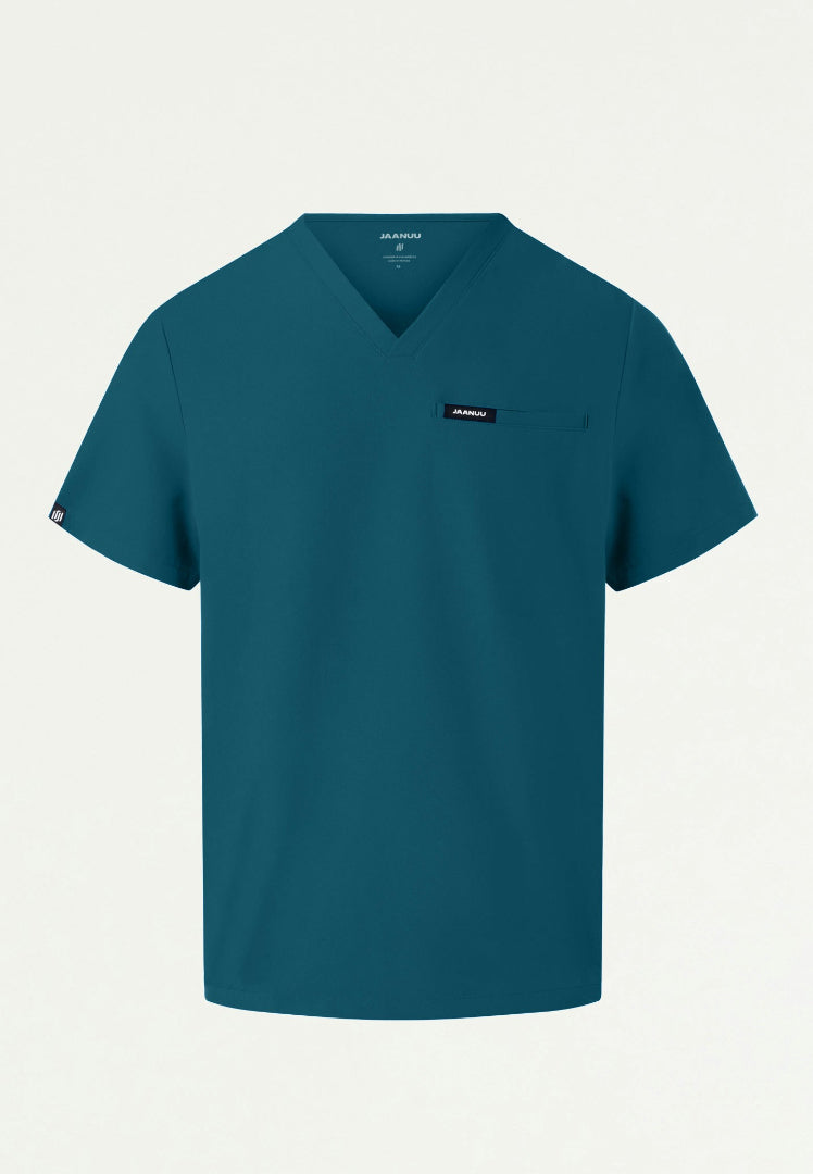 Caribbean blue Jaanuu Platt v-neck men's scrub shirt with a small logo on a light gray background