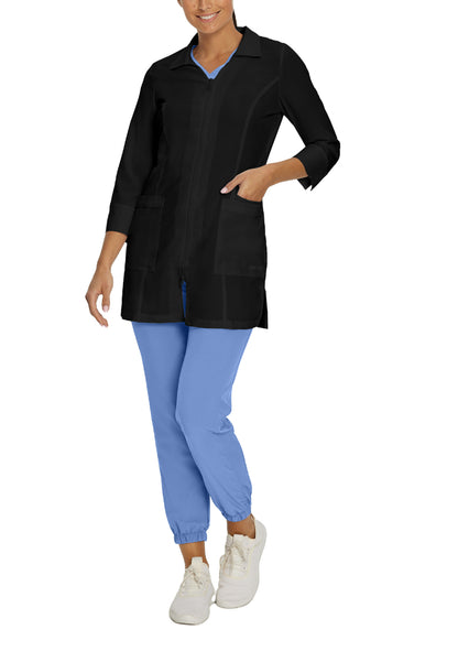 Person wearing a White Cross 2417 black lab coat and blue pants on a white background