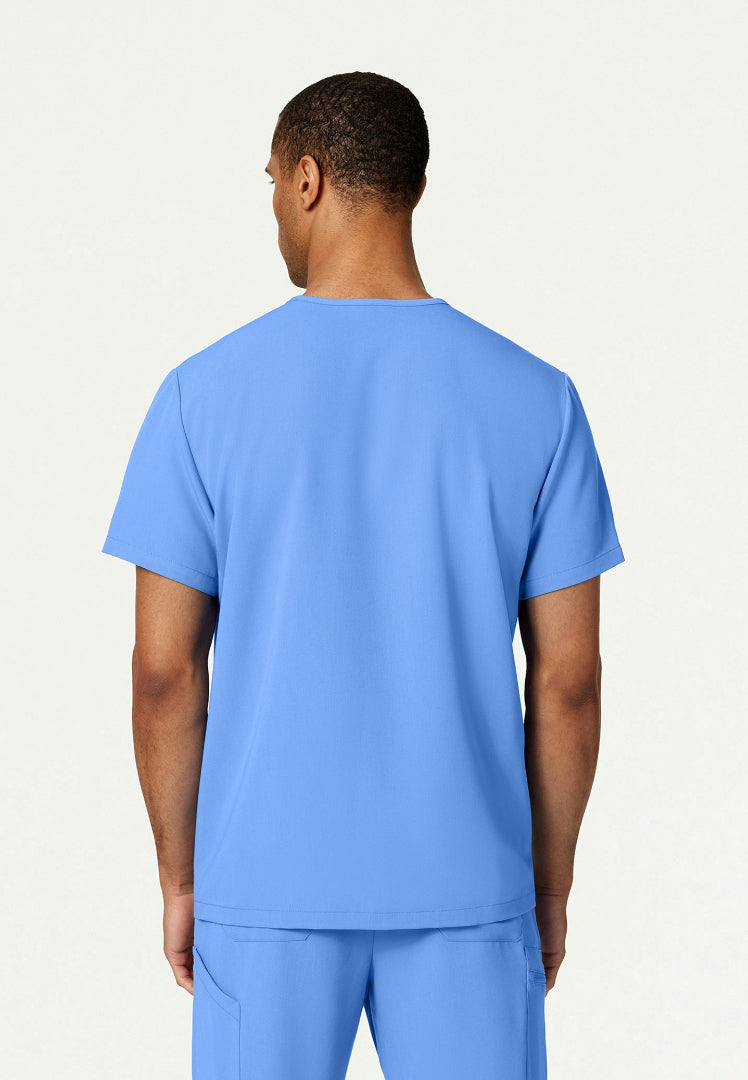 Back view of a man wearing a ciel blue Jaanuu Platt scrub shirt on a white background