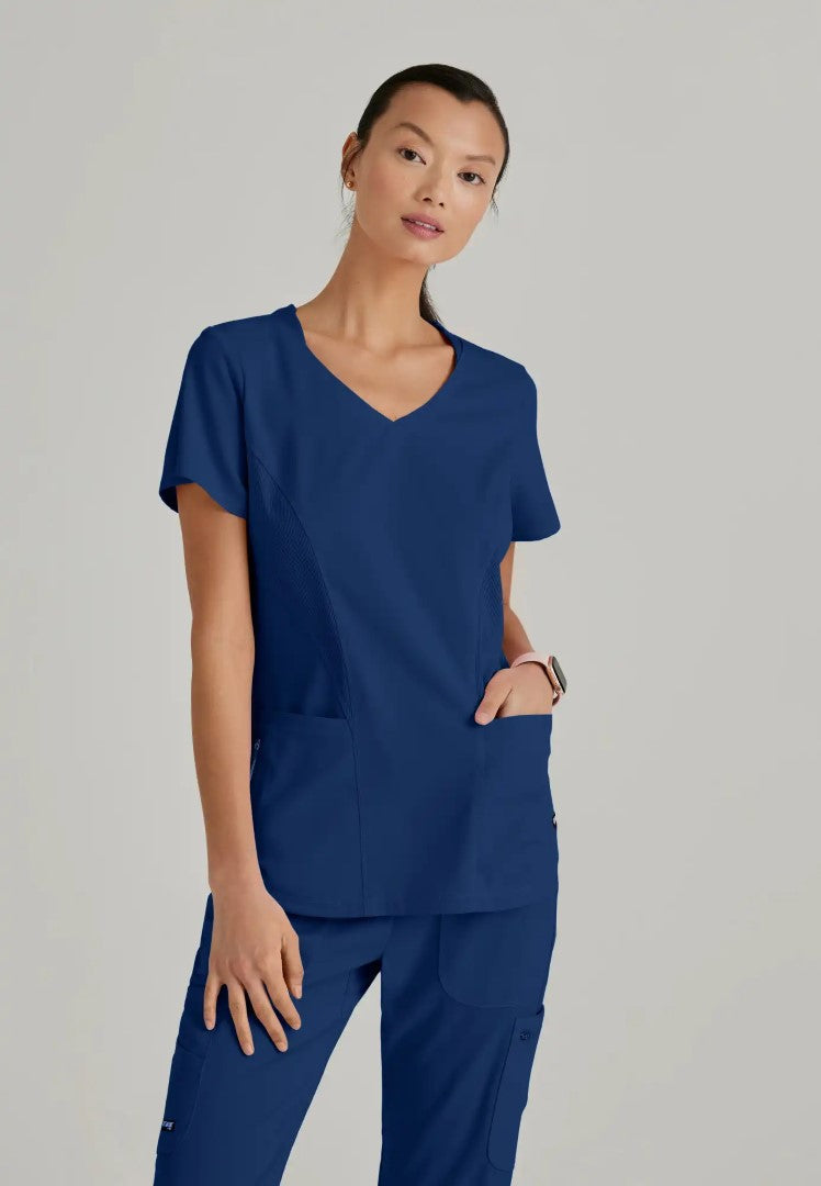 Grey's Anatomy™ Spandex Stretch "Carly" 3-Pocket Curved V-Neck Scrub Top - Indigo - The Uniform Store