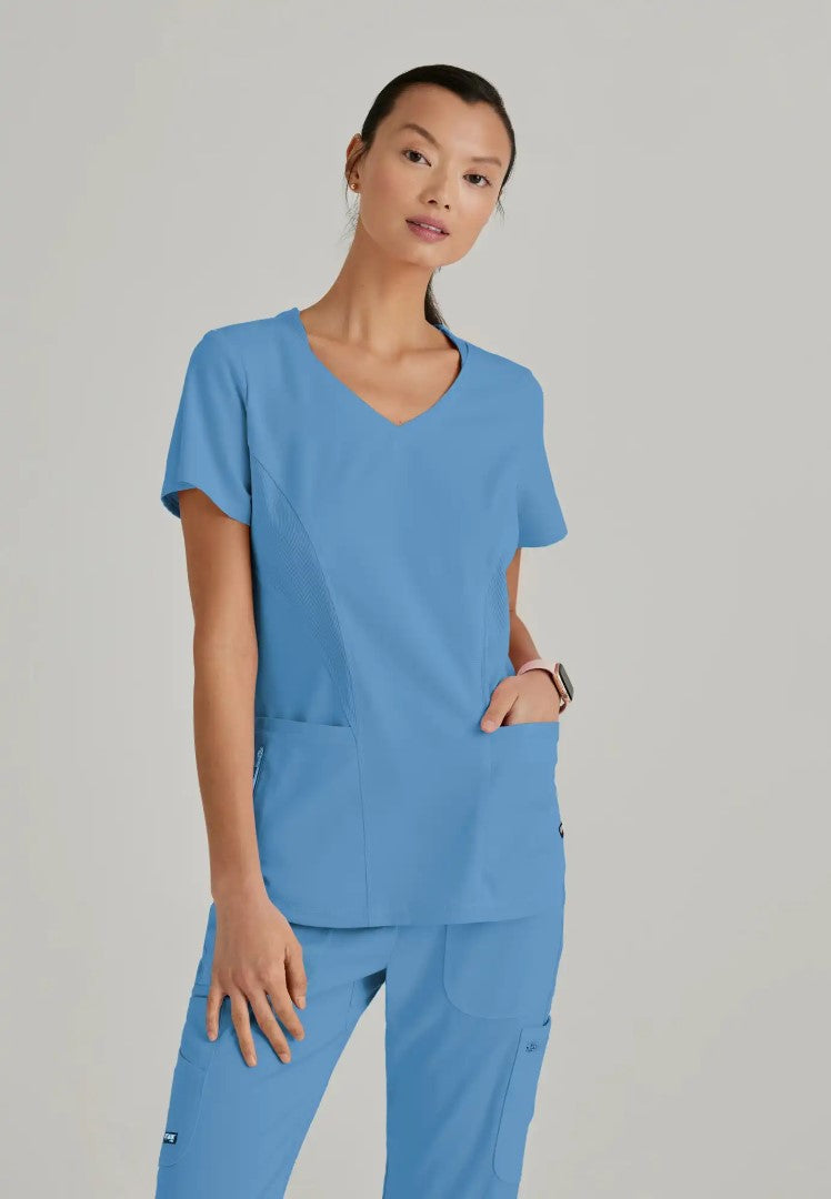 Grey's Anatomy™ Spandex Stretch "Carly" 3-Pocket Curved V-Neck Scrub Top - Ciel Blue - The Uniform Store