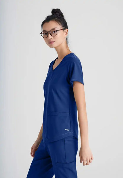 Grey's Anatomy™ Evolve "Rhythm" 2-Pocket Piped V-Neck Top - Indigo - The Uniform Store