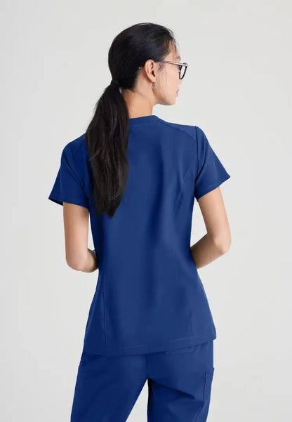 Grey's Anatomy™ Evolve "Sway" Banded V-Neck Tuck-In Top - Indigo - The Uniform Store