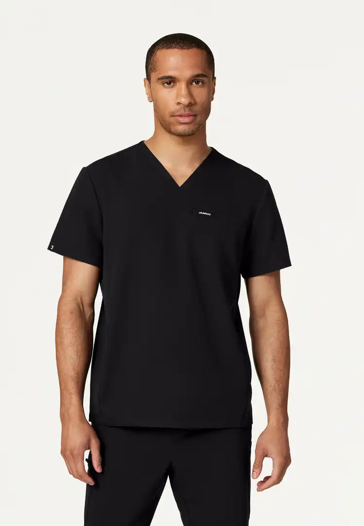 Man wearing a black Jaanuu Platt v-neck scrub top with a logo on a white background