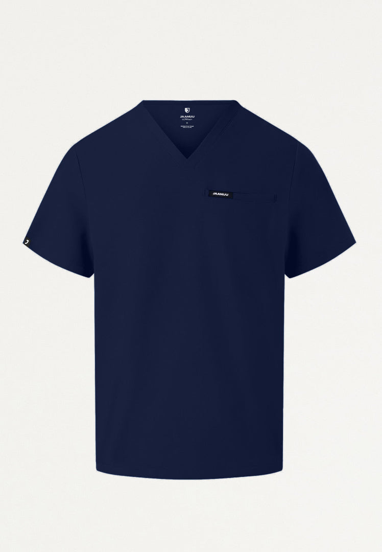Navy blue Jaanuu Platt v-neck scrub top with a small logo on a light gray background