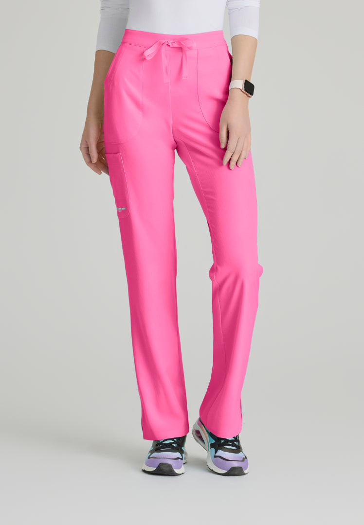 Woman wearing Skechers SK201 Passion Pink scrub pants on a light gray background