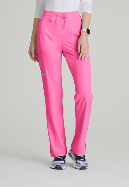 Woman wearing Skechers SK201 Passion Pink scrub pants on a light gray background