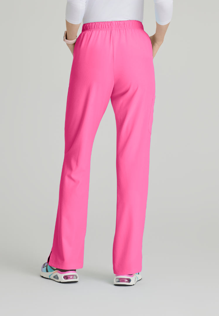 Back view of a woman wearing Skechers SK201 Passion Pink scrub pants on a light gray background