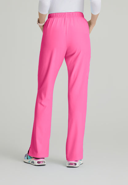 Back view of a woman wearing Skechers SK201 Passion Pink scrub pants on a light gray background
