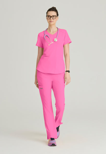 Woman wearing a Skechers Passion Pink medical scrub set (SK101 scrub shirt and SK201 scrub pant) with a stethoscope on a light gray background